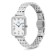 Daniel Wellington Quadro Roman Numerals Date watch featuring a rectangular silver case, a white dial with blue hands and Roman numerals, and a 5-link silver bracelet.