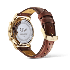 Rear view of the Daniel Wellington Iconic Chronograph St Mawes watch, showing the gold case back and the brown leather strap with its gold buckle.