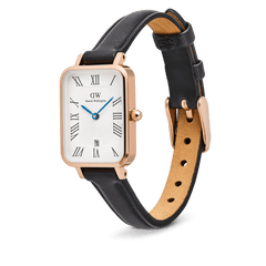 Daniel Wellington Quadro women's watch with a rectangular rose gold case, white dial with Roman numerals, a date window, and a black leather strap.