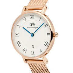Daniel Wellington Petite Roman Numerals Date watch with a rose gold mesh strap, white guillochÃ© dial, black Roman numerals, and vibrant blue hands.