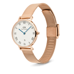 Daniel Wellington Petite Roman Numerals Date watch in rose gold with a white dial, Roman numerals, blue hands, and a mesh strap.