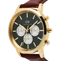 Daniel Wellington Iconic Chronograph watch in gold, featuring an emerald green panda dial with white sub-dials and a brown leather strap.